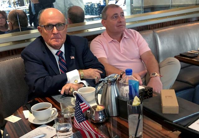 FILE PHOTO: U.S. President Donald Trump's personal lawyer Rudy Giuliani has coffee with Ukrainian-American businessman Lev Parnas at the Trump International Hotel in Washington, U.S. September 20, 2019.  REUTERS/Aram Roston/File Photo
