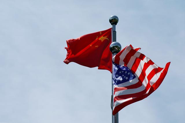 FILE PHOTO: Chinese and U.S. flags flutter near The Bund, before U.S. trade delegation meet their Chinese counterparts for talks in Shanghai, China July 30, 2019. REUTERS/Aly Song/File Photo/File Photo