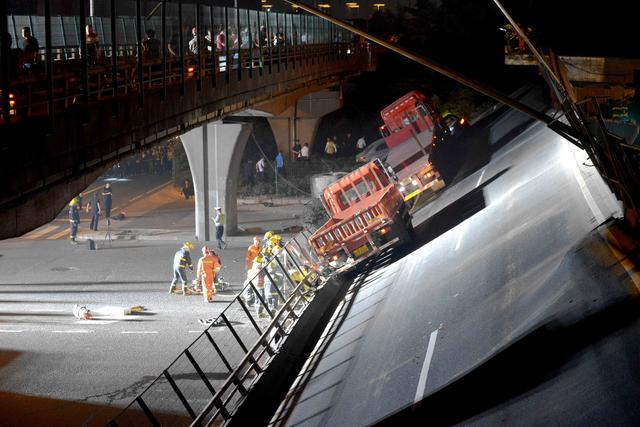 Rescue personnel and vehicles are seen at the site where a highway bridge collapsed in Wuxi, Jiangsu province, China October 10, 2019. Picture taken October 10, 2019. China Daily via REUTERS 