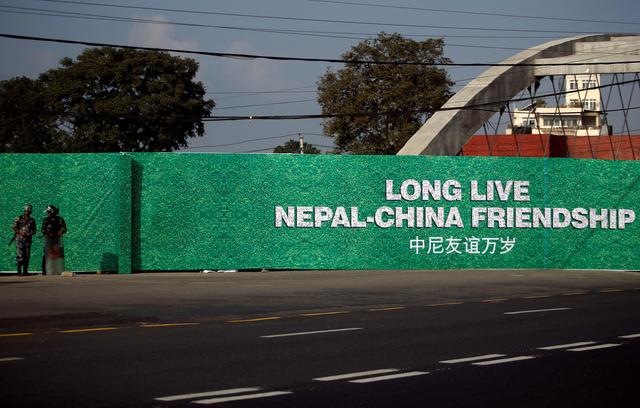 FILE PHOTO: Members of Nepalese police stand guard next to a hoarding ahead of the visit of China's President Xi Jinping, in Kathmandu, Nepal, October 11, 2019. REUTERS/Monika Deupala