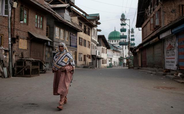 FILE PHOTO: A Kashmiri woman walks through an empty street in Anchar neighbourhood, during restrictions following the scrapping of the special constitutional status for Kashmir by the Indian government, in Srinagar, September 20, 2019. REUTERS/Danish Siddiqui