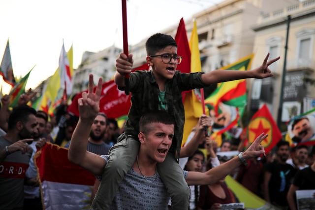 Kurds living in Greece shout slogans during a demonstration against Turkey's military action in northeastern Syria, in Athens, Greece, October 12, 2019. REUTERS/Alkis Konstantinidis