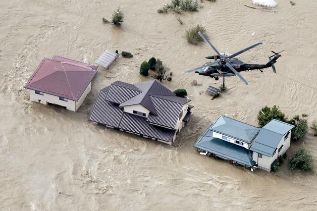 An aerial view shows a Japan Self-Defence Force helicopter flying over residential areas flooded by the Chikuma river following Typhoon Hagibis in Nagano, central Japan, October 13, 2019, in this photo taken by Kyodo. Mandatory credit Kyodo/via REUTERS