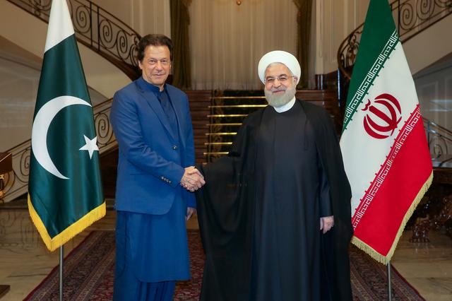 FILE PHOTO: Iranian President Hassan Rouhani shakes hands with Pakistani Prime Minister Imran Khan in Tehran, Iran, October 13, 2019. Official Presidential website/Handout via REUTERS