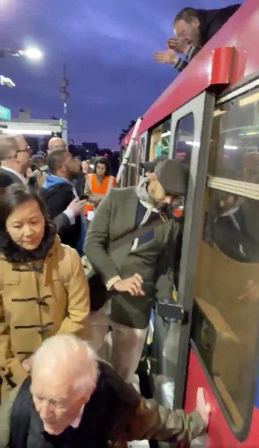 People look at Extinction Rebellion protesters glued onto the train at the Shadwell DLR station in London, Britain in this still image obtained from social media video dated October 17, 2019. TWITTER @MAXIMUS3005/via REUTERS