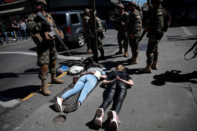 Soldiers detain suspected looters as protests against high living costs continue, in Concepcion, Chile October 22, 2019. REUTERS/Juan Gonzalez 