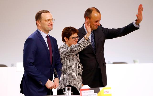 FILE PHOTO: Annegret Kramp-Karrenbauer waves with fellow candidates Jens Spahn and Friedrich Merz after being elected as the party leader during the Christian Democratic Union (CDU) party congress in Hamburg, Germany, December 7, 2018. REUTERS/Fabrizio Bensch/File Photo