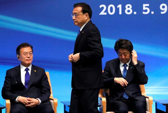 FILE PHOTO: Japan's Prime Minister Shinzo Abe, South Korea's President Moon Jae-in and China's Premier Li Keqiang attend the 6th JAPAN-CHINA-KOREA Business Summit in Tokyo, Japan May 9, 2018.  REUTERS/Toru Hanai/File Photo