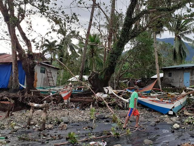 FILE PHOTO: A man walks past storm debris in Biliran, Philippines December 26, 2019. in this picture obtained from social media. VERMALYN MALOLOY-ON NAVARRETE via REUTERS 