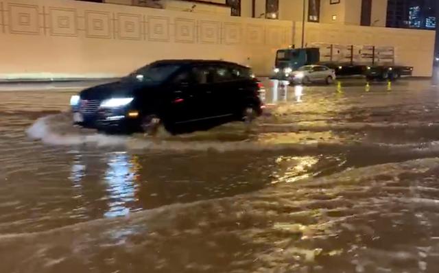 Cars drive through flooded streets in Dubai, United Arab Emirates, in the early hours of January 11, 2020 in this still image from social media video obtained by REUTERS    