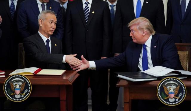 FILE PHOTO: Chinese Vice Premier Liu He and U.S. President Donald Trump shake hands after signing phase one of the U.S.-China trade agreement during a ceremony in the East Room of the White House in Washington, U.S., January 15, 2020. REUTERS/Kevin Lamarque