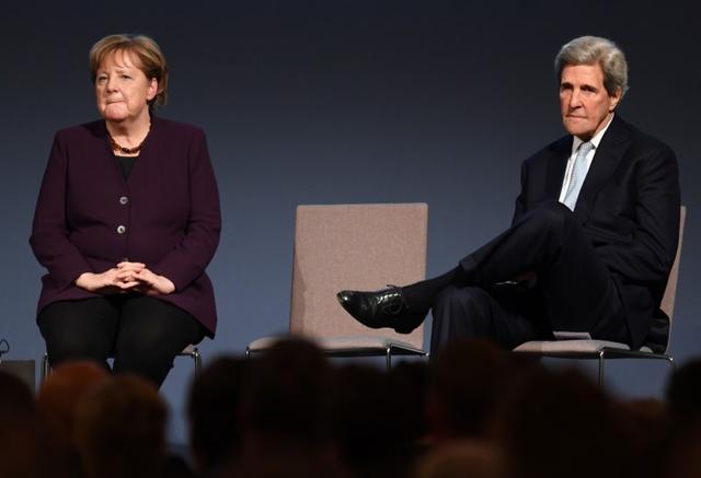 Former U.S. Secretary of State John Kerry and German Chancellor Angela Merkel attend the American Academy's Henry A. Kissinger Prize award ceremony at Charlottenburg Palace in Berlin, Germany, January 21, 2020.  REUTERS/Annegret Hilse