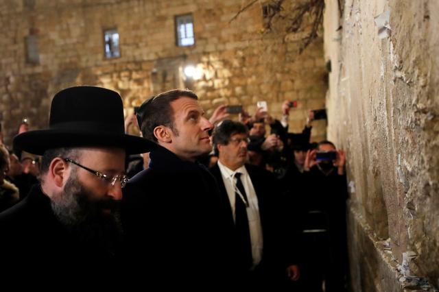 French President Emmanuel Macron stands by the Western Wall, the holiest site where Jews can pray in Jerusalem's Old City, during a visit in Jerusalem January 22, 2020. REUTERS/Ammar Awad