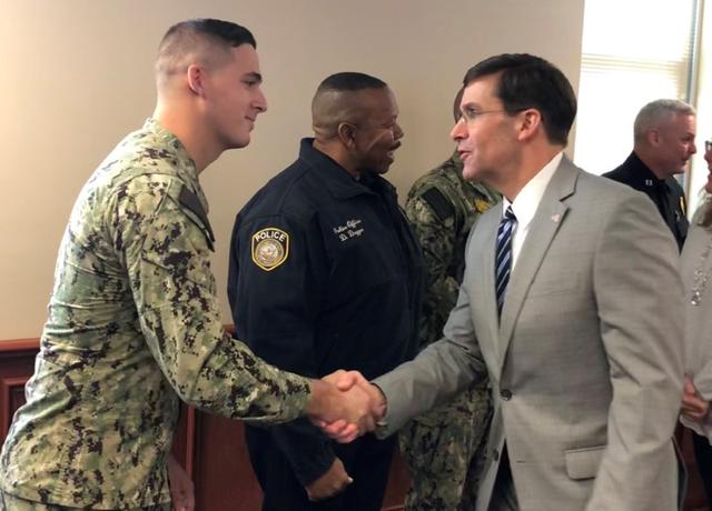 U.S. Defense Secretary Mark Esper meets Navy sailor David Link, one of the first responders at the scene of a December 6, 2019 shooting at Naval Air Station Pensacola by a Saudi military officer that killed three U.S. sailors, at the base in Pensacola, Florida, U.S., January 22, 2020. REUTERS/Phil Stewart