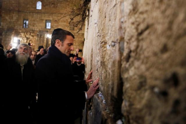 FILE PHOTO: French President Emmanuel Macron stands by the Western Wall, the holiest site where Jews can pray in Jerusalem's old city, during a visit in Jerusalem January 22, 2020. REUTERS/Ammar Awad/File Photo