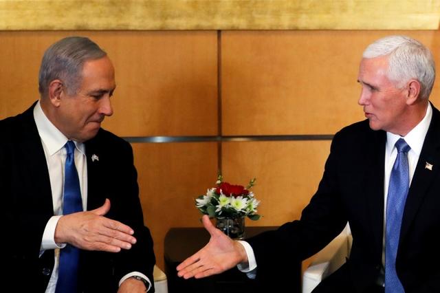 Israeli Prime Minister Benjamin Netanyahu and U.S Vice President Mike Pence prepare to shake hands during their meeting at the U.S embassy in Jerusalem January 23, 2020. REUTERS/Ammar Awad