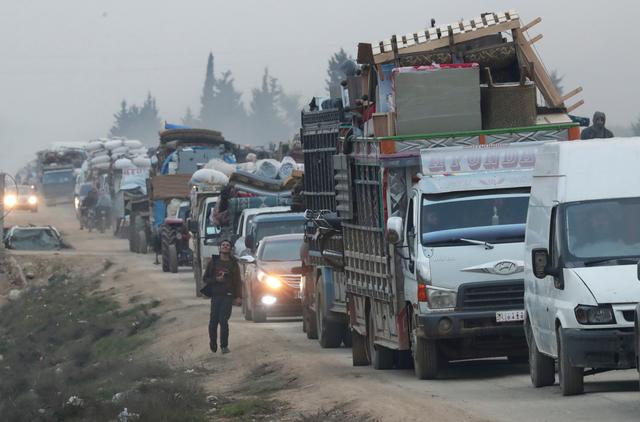 FILE PHOTO: A view of trucks carrying belongings of displaced Syrians, is pictured in the town of Sarmada in Idlib province, Syria, January 28, 2020. REUTERS/Khalil Ashawi/File Photo