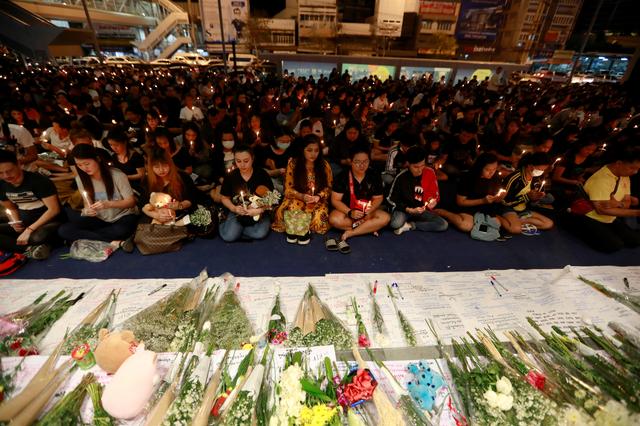 People gather as they pray for victims who died in a mass shooting, in front of Terminal 21 shopping mall in Nakhon Ratchasima, Thailand February 10, 2020. REUTERS/Soe Zeya Tun