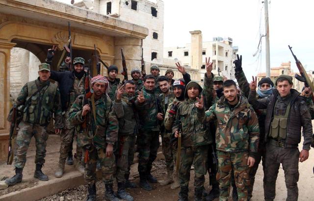 Syrian army soldiers gesture in al-Rashideen area in Aleppo province, Syria, in this handout released by SANA on February 16, 2020. SANA/Handout via REUTERS 