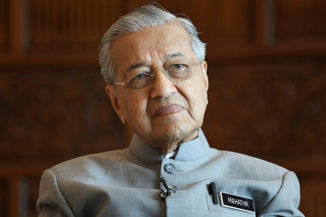 FILE PHOTO: Malaysia's Prime Minister Mahathir Mohamad looks on during an interview with Reuters in Putrajaya, Malaysia, December 10, 2019. REUTERS/Lim Huey Teng