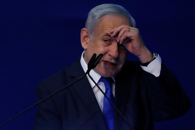 FILE PHOTO: Israeli Prime Minister Benjamin Netanyahu gestures as he speaks to supporters following the announcement of exit polls in Israel's election at his Likud party headquarters in Tel Aviv, Israel March 3, 2020. REUTERS/Ammar Awad
