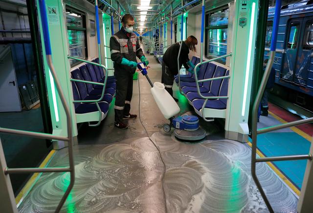 Employees wearing protective face masks clean and disinfect a subway train, as part of measures to prevent the spread of coronavirus (COVID-19) in Moscow, Russia March 16, 2020. REUTERS/Tatyana Makeyeva