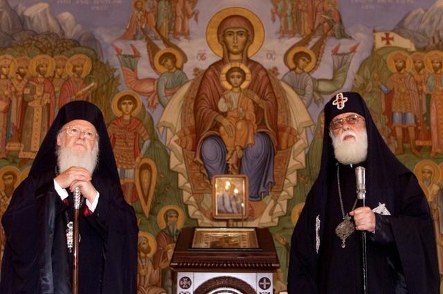 FILE PHOTO: Ecumenical Patriarch and Archibishop of Constantinople Bartholomew (L)  and Georgian Orthodox Patriarch Ilya II listen to a choir at the  Georgian Patriarchate building in Tblisi September 20, 2003. Patriarch  Bartholemew arrived in Georgia on Saturday to take part in celebrations  for the 1000th anniversary of the Bagrati Cathedral in western Georgia.  REUTERS/David Mdzinarishvili/File Photo