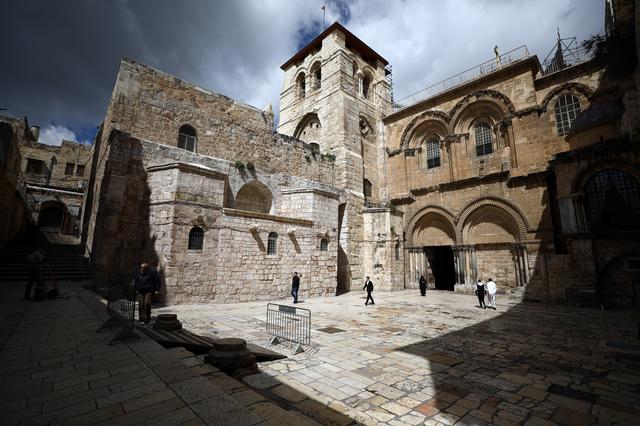 FILE PHOTO: A general view shows Church of the Holy Sepulchre, revered as the site of Jesus's crucifixion and burial, as a prayer session takes place inside the church amid concerns over the spread of coronavirus disease (COVID-19), in Jerusalem's Old City March 22, 2020. REUTERS/Ammar Awad