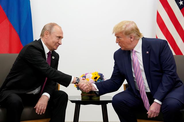 FILE PHOTO: Russia's President Vladimir Putin and U.S. President Donald Trump shake hands during a bilateral meeting at the G20 leaders summit in Osaka, Japan, June 28, 2019.  REUTERS/Kevin Lamarque