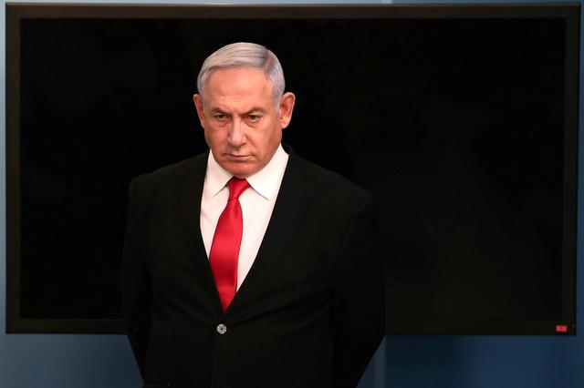 FILE PHOTO: Israeli Prime Minister Benjamin Netanyahu arrives for a speech at his Jerusalem office, regarding the new measures that will be taken to fight the coronavirus, March 14, 2020. Gali Tibbon/Pool via REUTERS