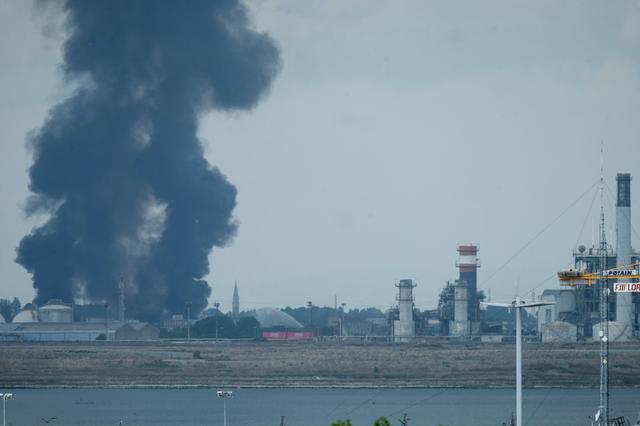 Large clouds of black smoke billows from a chemical plant after an explosion, in Marghera, seen from Venice, Italy, May 15, 2020 REUTERS/Manuel Silvestri