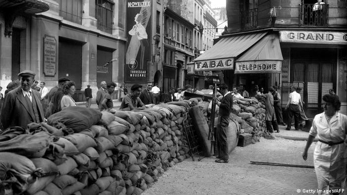 Parisians finish building a barricade at Rue du Renard next to the Paris City Hall (Hotel de Ville) in August 1945 during the Liberation of Paris
